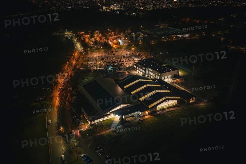 Night view of an illuminated building structure with surrounding parking spaces, Sindelfingen, Böblingen district, Germany