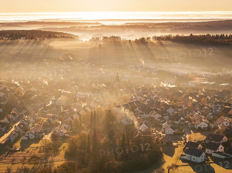 View of a village from above, rays of light and fog create an atmospheric atmosphere, Gechingen, Hecken and GÃ¤u region, Calw district, Germany