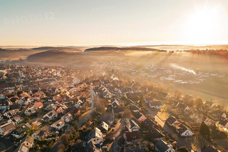 Sunrise over a village bathed in golden twilight shades, Gechingen, Hecken and GÃ¤u region, Calw district, Germany