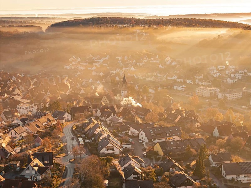 Fog-covered village with church tower in morning light with surrounding hills and mountains, Gechingen, Hecken and GÃ¤u region, Calw district, Germany