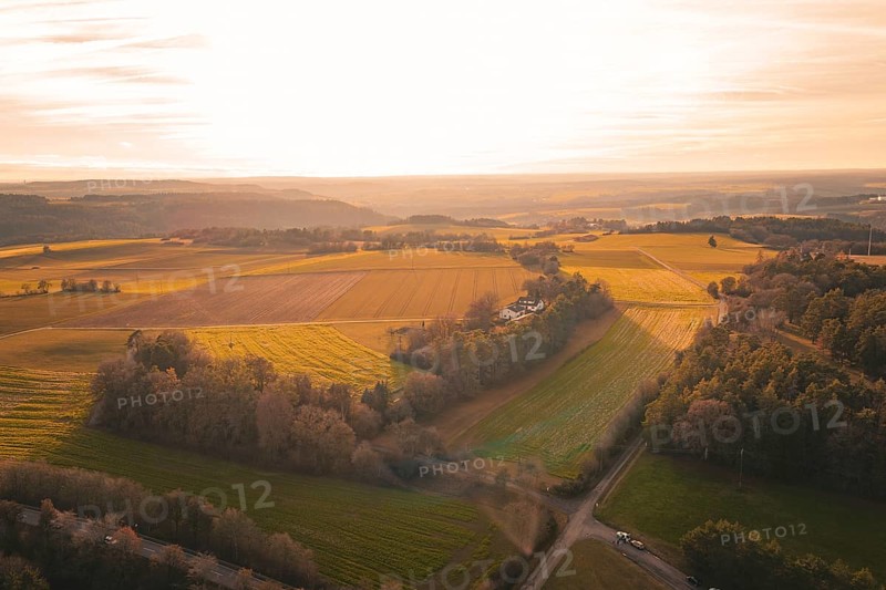 Extensive fields in soft sunset light with views of distant hills, Gechingen, Hecken and GÃ¤u region, Calw district, Germany