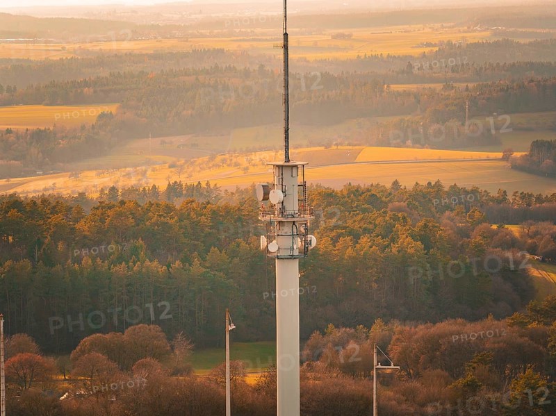 Close-up of a radio tower over a forest and field landscape in warm light, Gechingen, Hecken and GÃ¤u region, Calw district, Germany