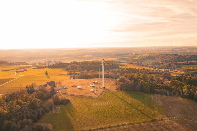 Single radio tower in an open field surrounded by forests in the evening light, Gechingen, Hecken and GÃ¤u region, Calw district, Germany