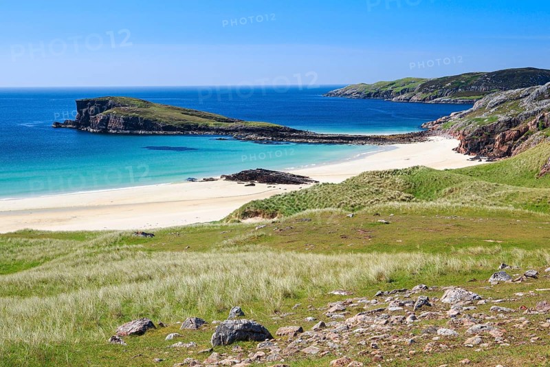 Dunes covered with beach oats line the idyllic sandy beach of Oldshoremore on the west coast of Scotland
