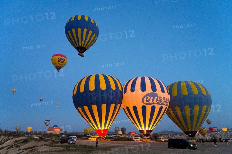 Several colorful hot air balloons rise in the morning sky over a vast landscape, Göreme National Park, Göreme Tarihî Millî Park, Nevsehir Province, NevÅŸehir, Cappadocia, Capadocia, Central Anatolia, Turkey