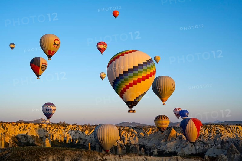 Colourful hot air balloons over a rocky landscape in soft morning light convey a sense of adventure, Göreme Tarihî Millî Park, Nevsehir Province, Nevsehir, Cappadocia, Capadocia, Cappadocia, Central Anatolia, Turkey