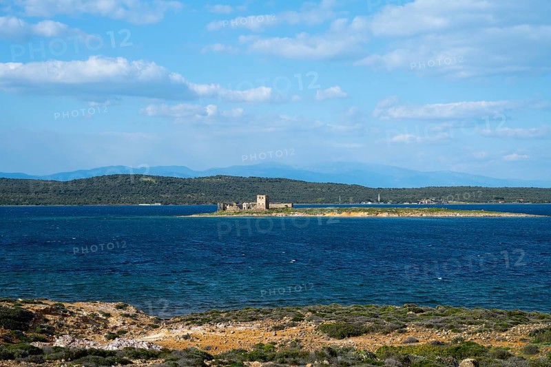 A small island with ruins is surrounded by a deep blue sea under clear skies, ruins of Agios Yorgis Monastery or St. George or Kizlar Manastiri on Dove Island, GÃ¼vercin Island, view from Alibey AdasÄ± Island, Cunda AdasÄ±, Ayvalik Islands, Ayvalik, Aegean Sea, Turkey
