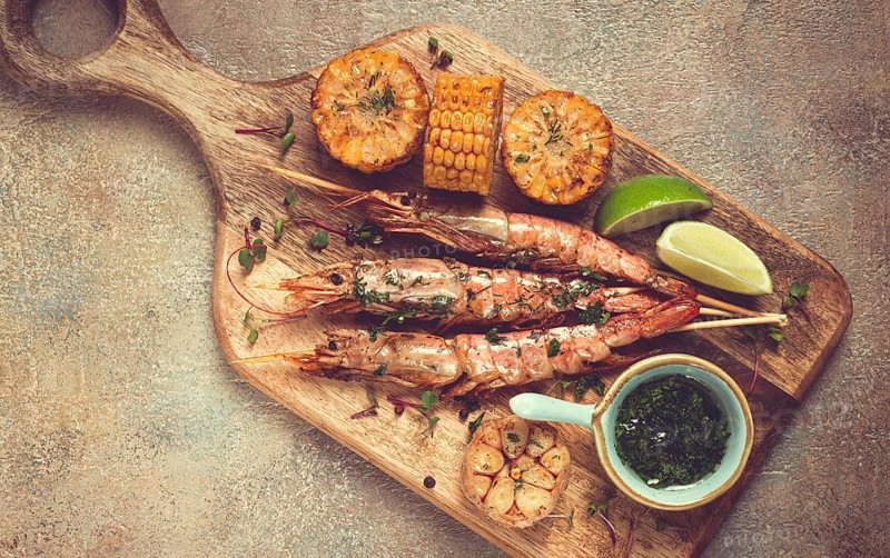 Langoustines on skewers, shrimp kebab, with fried corn, spices and herbs, homemade, no people