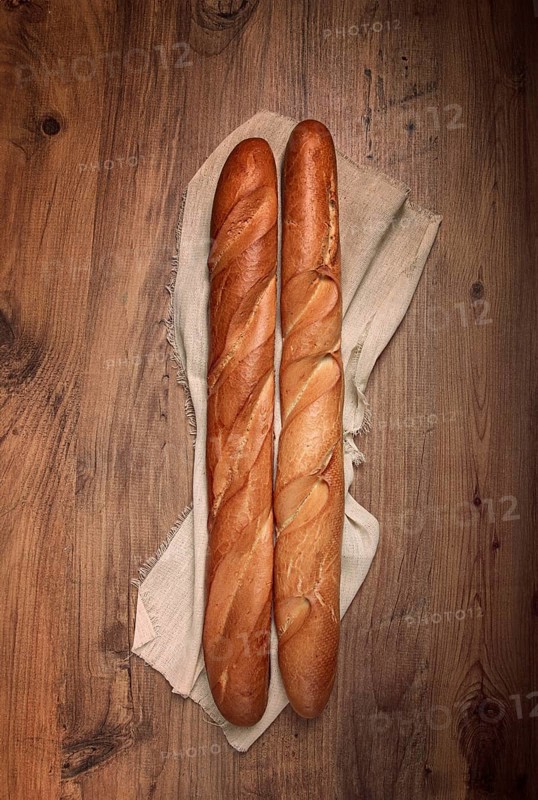 Fresh French baguette, two pieces, top view, on the table, no people