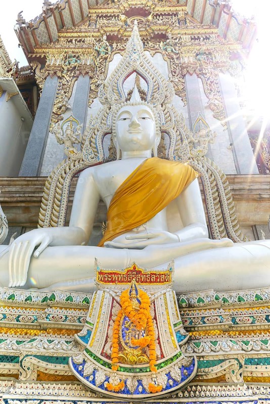 Buddha statue with tunic, Bhumispara mudra, Buddha Gautama at the moment of enlightenment, at the entrance to Wat Sitthawararam, Bangkok, Thailand