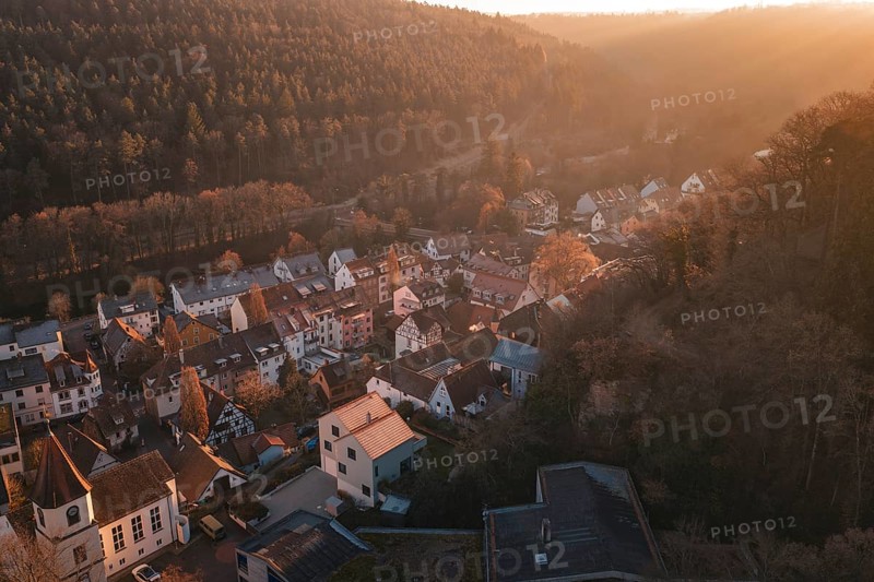 Village captured in warm light on the edge of a forest under a golden sky, Dillweisenstein, Pforzheim, Germany