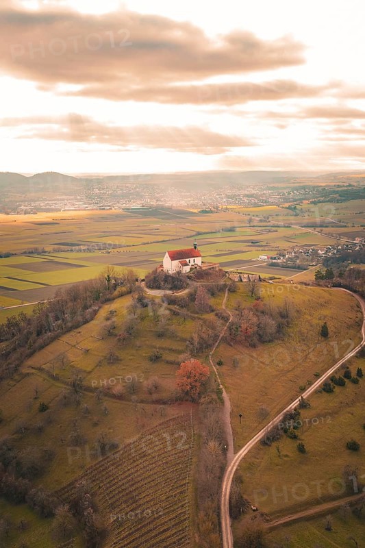 Church on a hill with a wide view over the rolling hills and fields in the distance, Wurmlinger Chapel, Rottenburg am Neckar, Germany