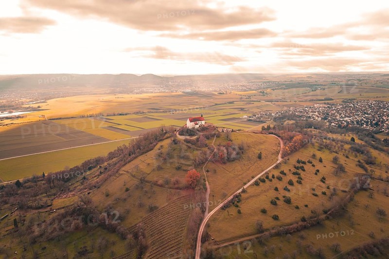 Church on hill with wide views of fields and villages under cloudy sky, Wurmlinger Chapel, Rottenburg am Neckar, Germany