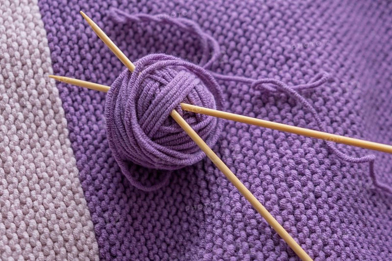 Close-up purple knitting with balls of wool and needles, North Rhine-Westphalia, Germany
