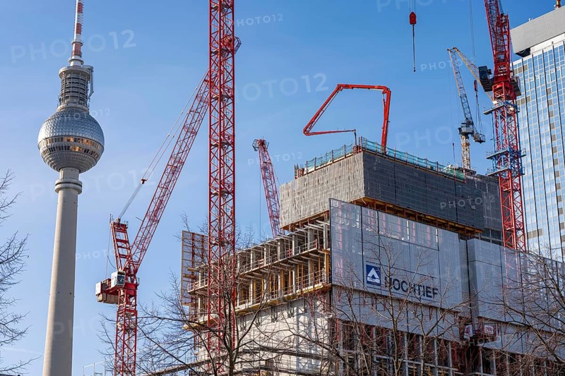 Construction site of the Covivio high-rise building at the front, in the vicinity of Alexanderplatz in Berlin, mixed use of apartments, offices, retail and a daycare center, the high-rise construction site of The Berlinian office high-rise building, dome of the Berlin TV Tower, Germany