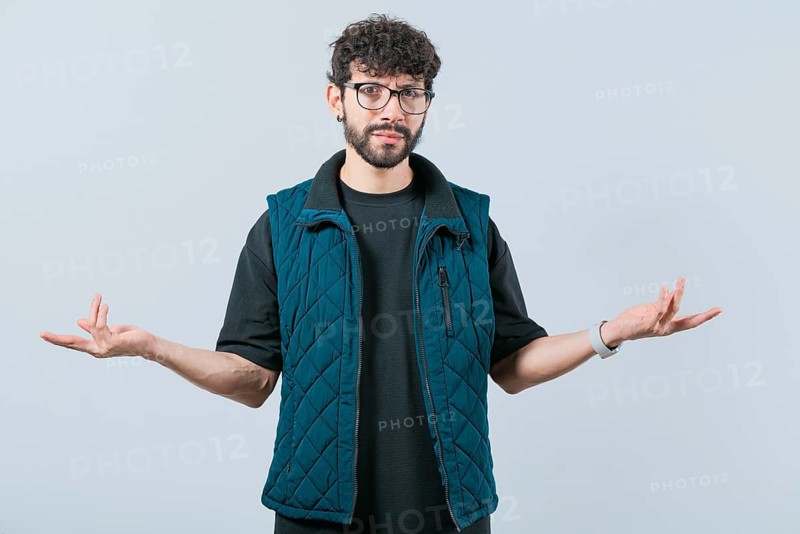 Confused man spreading hands bewildered isolated. Unsure person with face worried