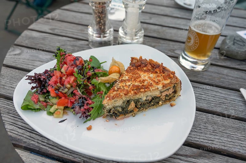 Quiche served with spinach and salad in a garden café, Ahrenshoop, DarÃŸ, Mecklenburg-Vorpommern, Germany