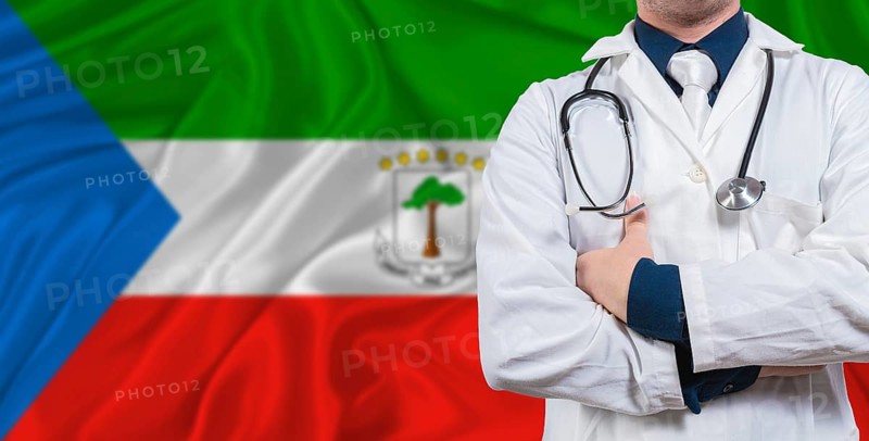 Male doctor with stethoscope on Equatorial Guinea flag. Doctor holding stethoscope on Equatorial Guinea flag