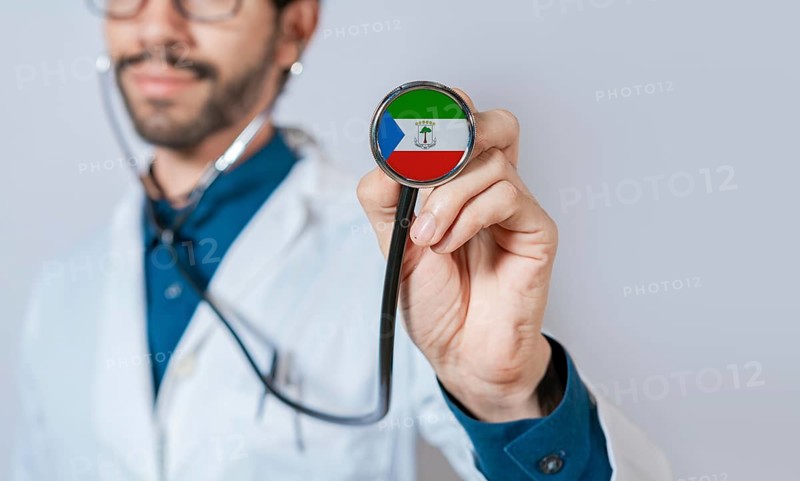 Doctor holding stethoscope with Equatorial Guinea flag. Equatorial Guinea health and care concept. Equatorial Guinea flag on stethoscope