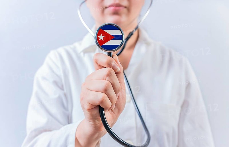 Female doctor holding stethoscope with Cuba flag. National health system of Cuba