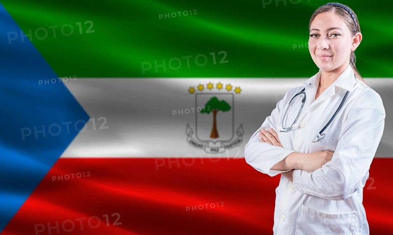 Female doctor on Equatorial Guinea flag. Doctor with crossed arms on Equatorial Guinea flag. Equatorial Guinean health and care concept