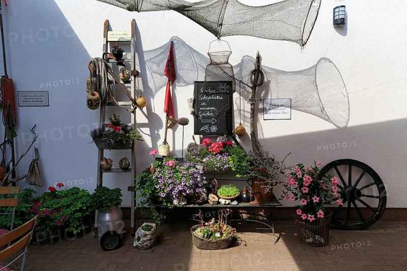 Decorative garden corner, maritime and rural elements, flower pot, garden restaurant, MÃ¶nchgut, RÃ¼gen, Germany