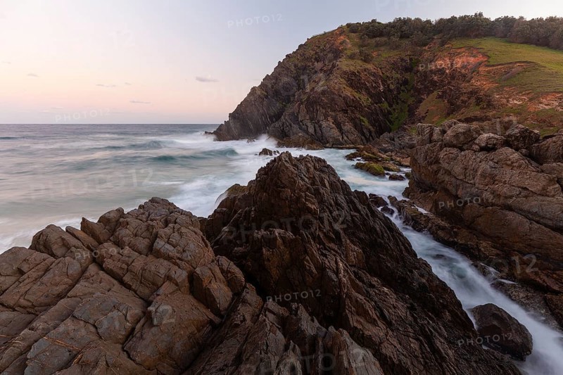 Rocks at the easternmost point of mainland Australia at sunset. Cape Byron near Byron Bay, New South Wales, Australia