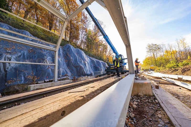 Construction work on a metal structure over railway lines in autumn surroundings, Hermann Hesse Railway bat tunnel construction site, Calw, Black Forest, Germany