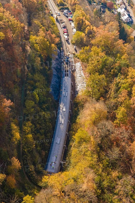 Tunnel project view from the air, surrounded by diverse autumn forest and infrastructure, Hermann Hesse Railway bat tunnel construction site, Calw, Black Forest, Germany