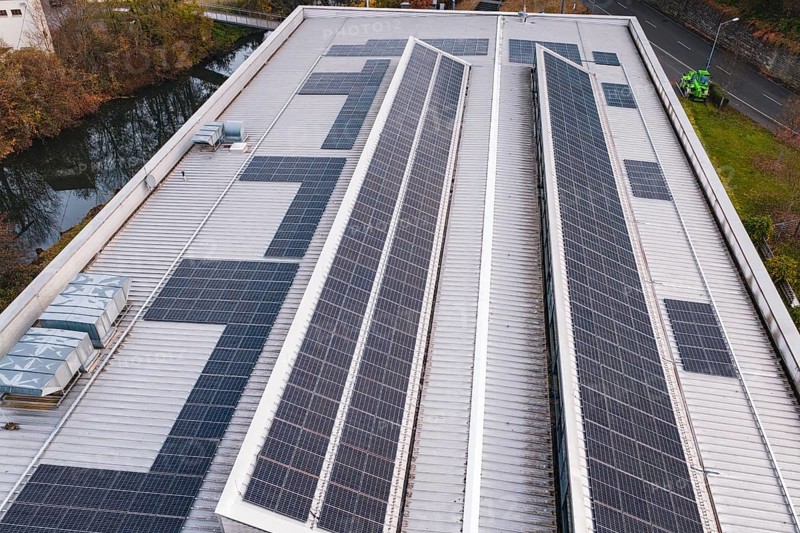 Roof with solar panels on an industrial building in an urban environment, PV at Walther Lindner Sporthalle Calw, Black Forest, Germany