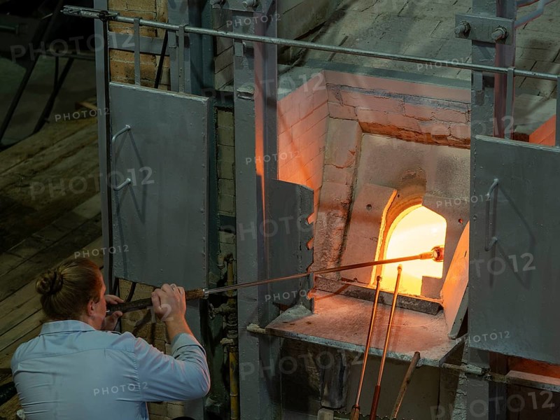 Glassblowers at work in front of kiln, Bohemia, Czech Republic