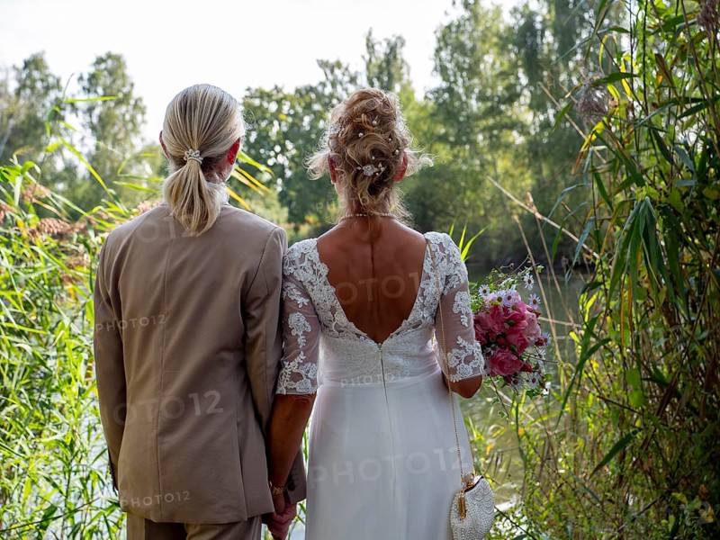 Elderly couple's wedding, look at the lake and reeds and look at the water
