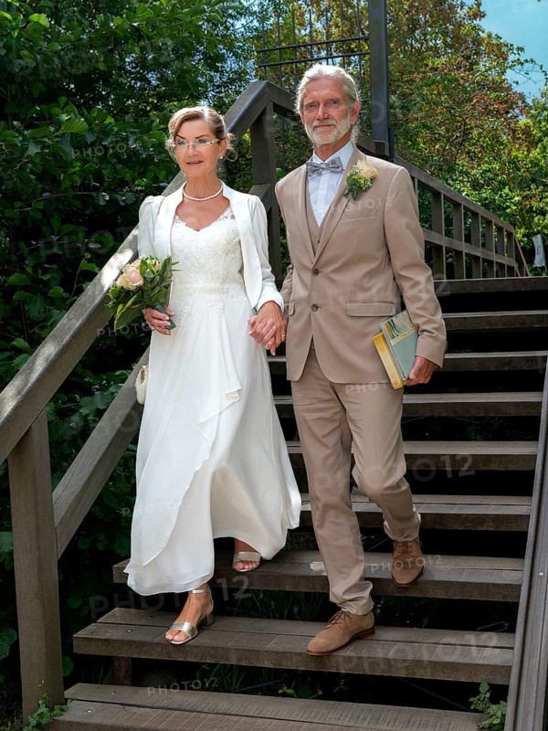 Elderly couple's wedding on wooden bridge