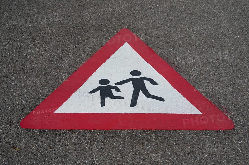 Traffic sign, children playing, road with marking on the asphalt, Bavaria, Germany