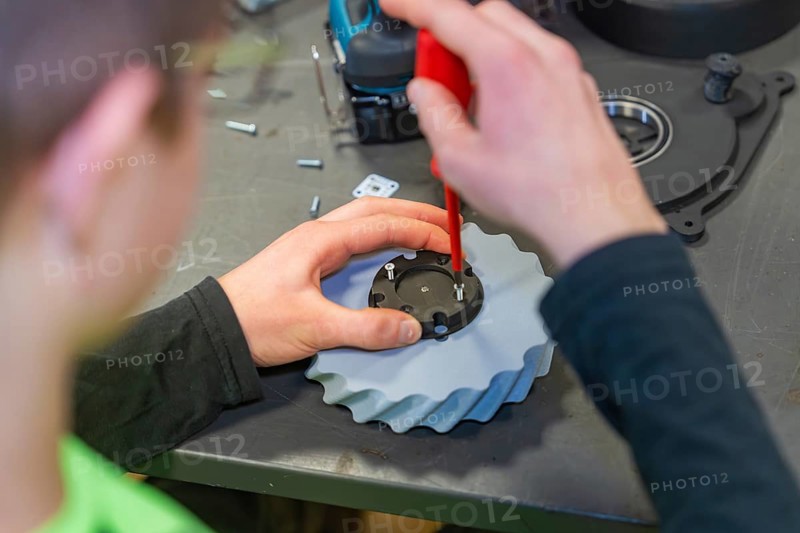 Gear assembly with screwdriver in the workshop, Jugend Forschungszentrum Nagold, Calw district, Germany