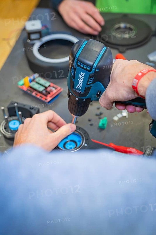 Person uses drills to secure components to a table, Jugend Forschungszentrum Nagold, Calw district, Germany