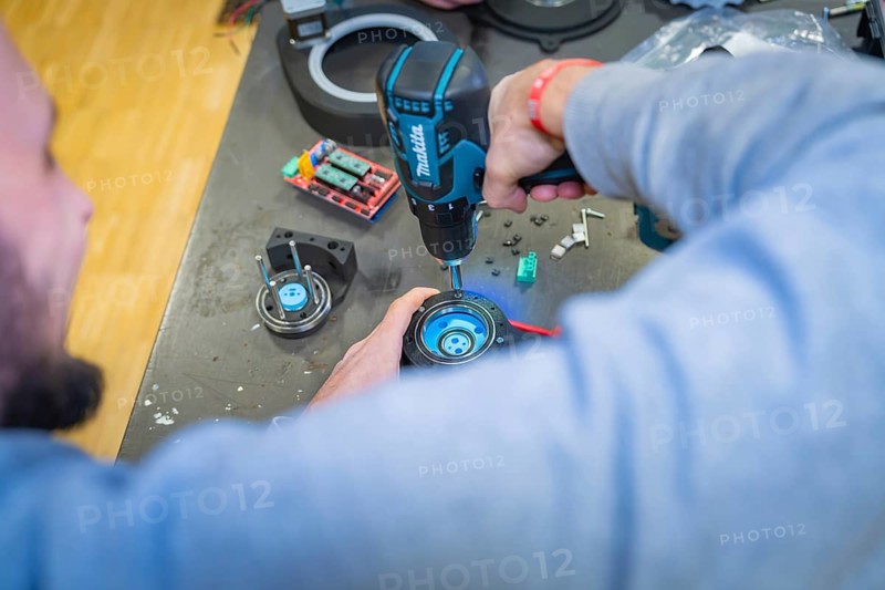 Person using drills on a component on a table, Jugend Forschungszentrum Nagold, Calw district, Germany