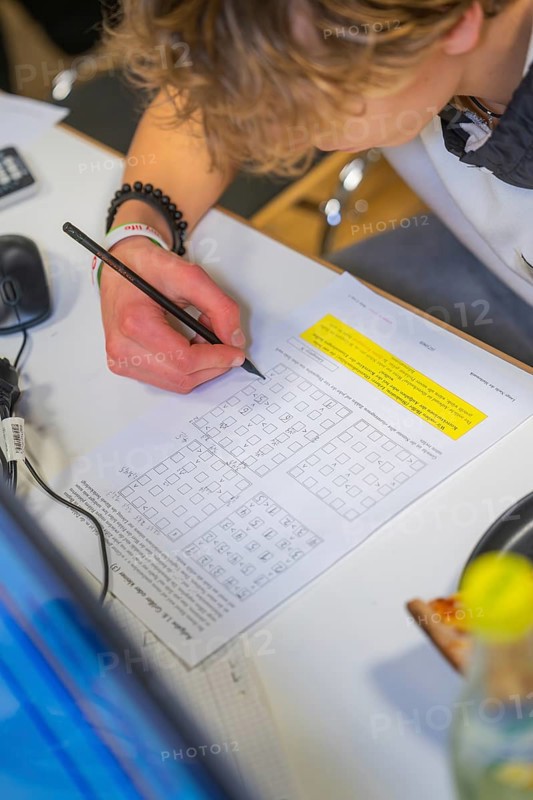 Young person working on math problems at a desk, Jugend Forschungszentrum Nagold, Calw district, Germany