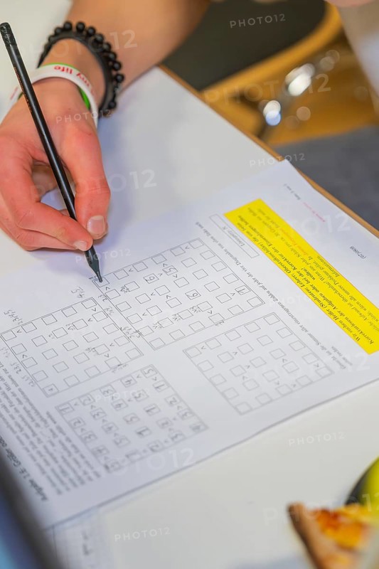 Hand writes math problems on a worksheet, Jugend Forschungszentrum Nagold, Calw district, Germany