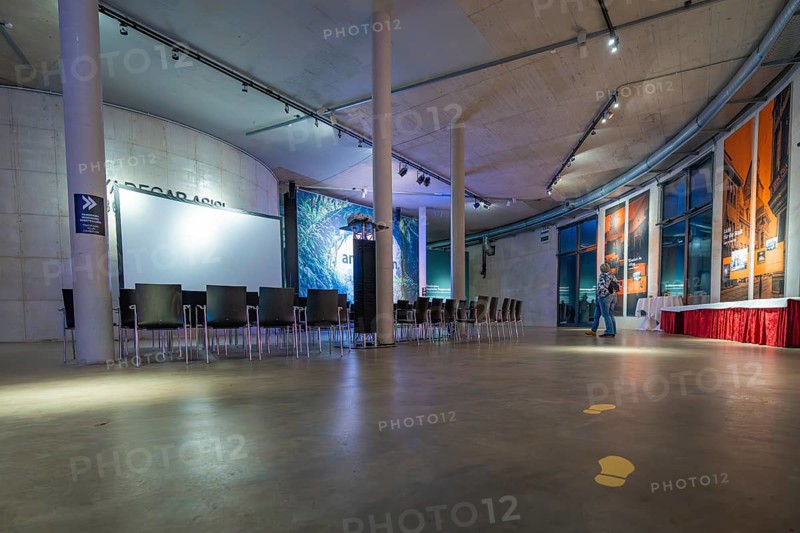 A modern gallery space with chairs and atmospheric lighting, Amazonia exhibition, Gasometer, Pforzheim, Germany