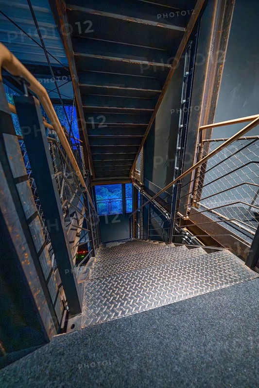 Stairs with industrial design in blue light at night, Amazonia exhibition, Gasometer, Pforzheim, Germany