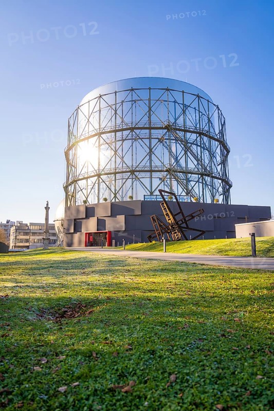 Round steel structure with green lawn underneath under blue sky, Amazonia exhibition, Gasometer, Pforzheim, Germany