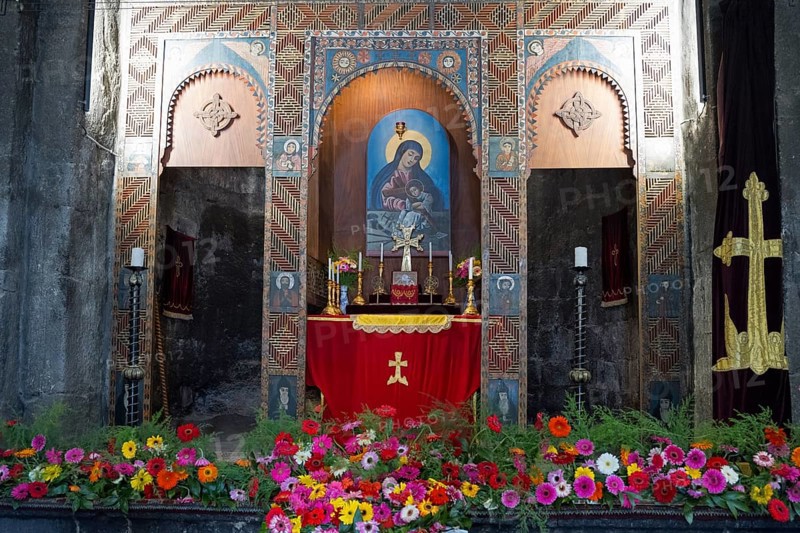 Magnificent altar in a church decorated with colorful flowers and religious paintings, Sevanavank Monastery, Gegharkunik Province, Armenia