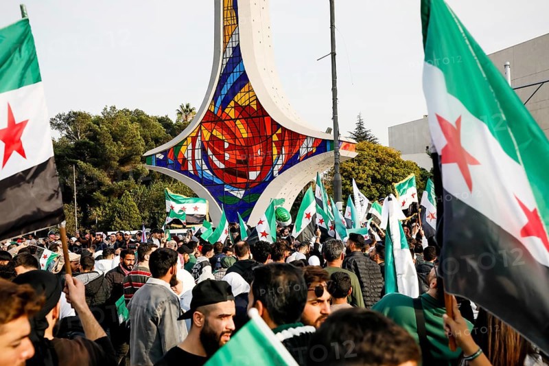 Damascus, Syria. November 28, 2025: Thousands of Syrians gather in Umayyad Square in central Damascus to celebrate the anniversary of the military operation that led to the fall of Bashar al-Assad's regime. Demonstrators express joy and unity while denouncing Israeli attacks on Syrian territory, Damascus, Damascus, Syria