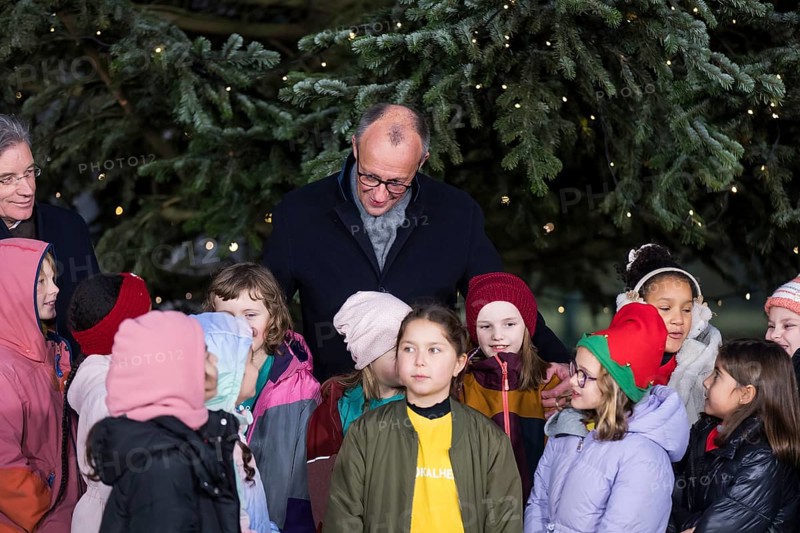 Friedrich Merz (CDU, Federal Chancellor of the Federal Republic of Germany) talks to children from the Vokalhelden Children's Choir from Schöneberg elementary schools at the handing over of the Christmas tree to the Federal Chancellery, Berlin, 28.11.2025