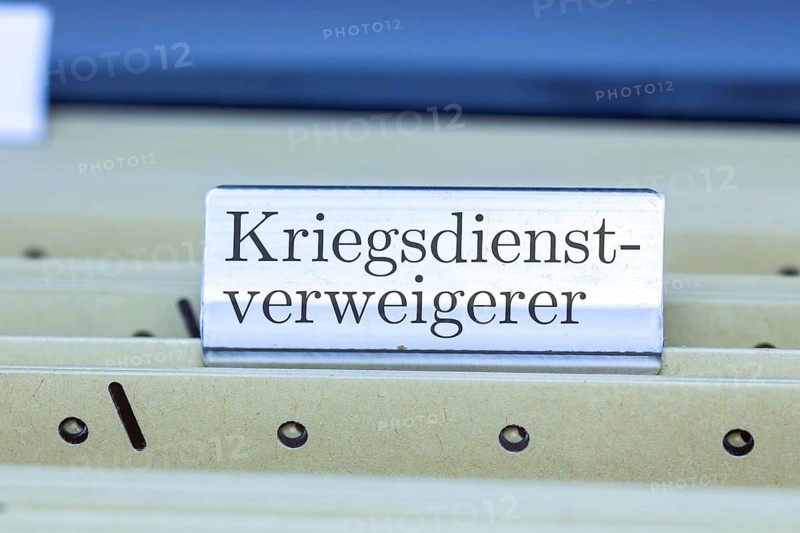 (photo montage) Sign with the inscription CONSCIENTIOUS OBJECTOR on a hanging file register
