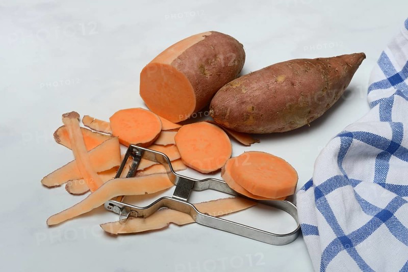 Sweet potatoes with potato peeler, potato slices, partially peeled, Ipomoea batatas