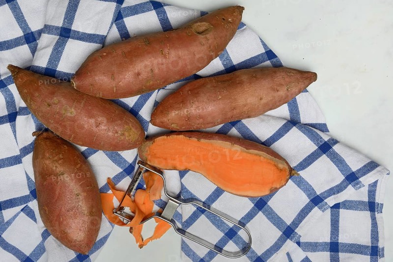Sweet potatoes with potato peeler, Ipomoea batatas