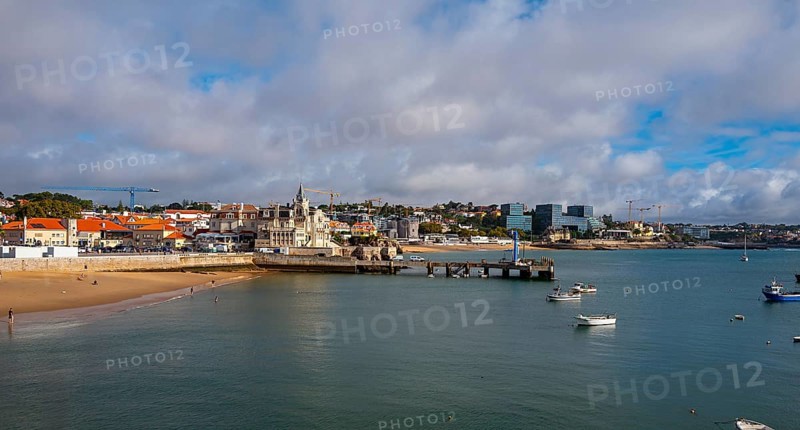 View of the old town and a small stretch of beach by the sea, Cascais, Portugal