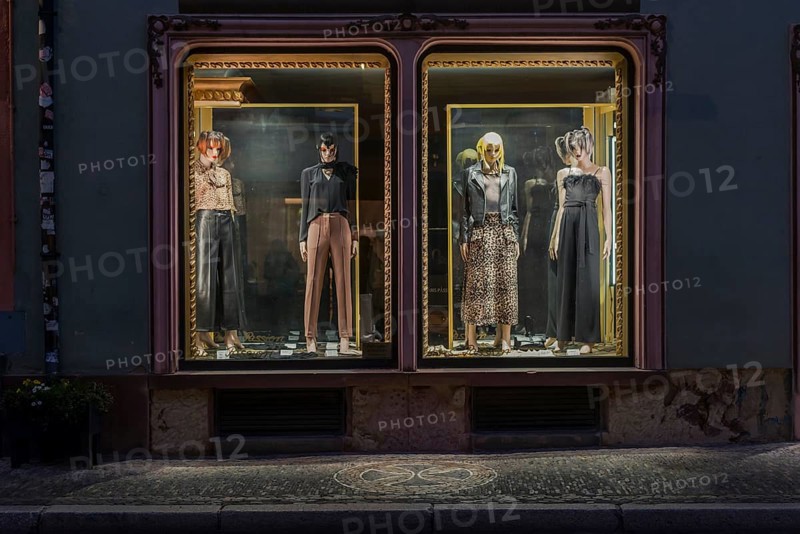 Fashion shop in evening mood with illuminated shop window